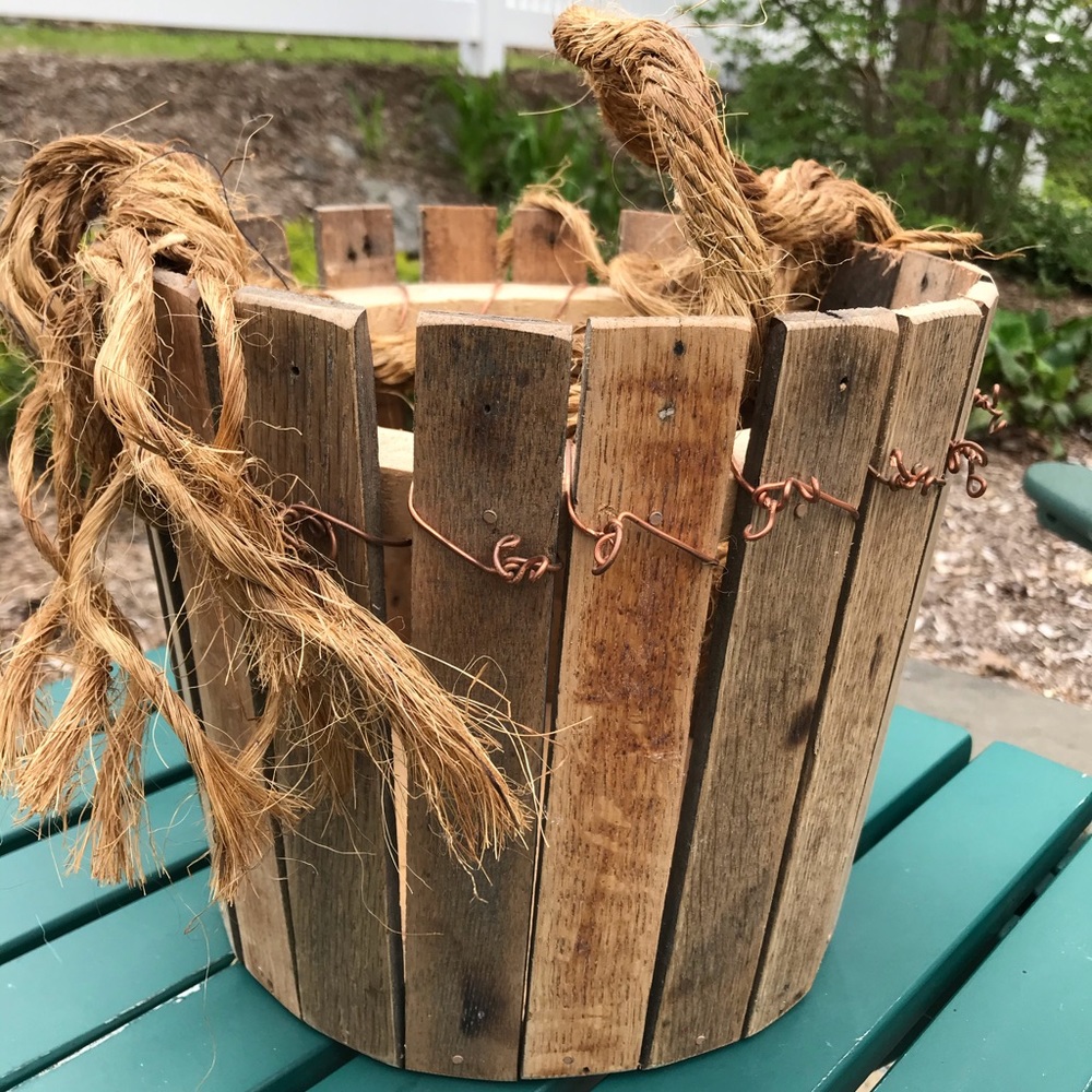 Rustic handmade wooden basket with rope handle
